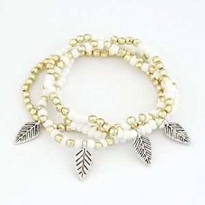 White and gold stretch bracelet with leaf charms.