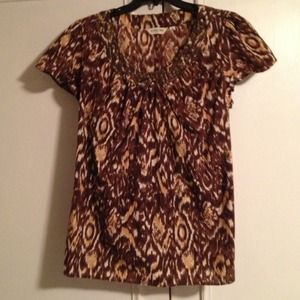 Cute top with beading around the neckline.