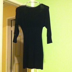 Black long sleeve knee length dress.