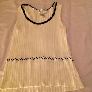 Creme colored sweater with black braiding on neck.