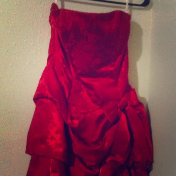 Mid thigh length, red, strapless dress.