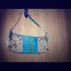 Coach signature fabric and suede details.