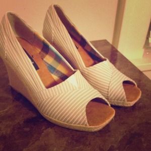 Tan and white striped wedge shoes.