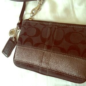 Cute black Coach wristlet with pewter stripe