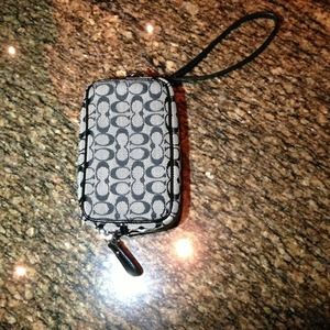 Used Authentic Coach cellphone holder.