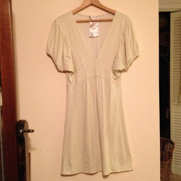 Comfy dress cream with tiny black pika dots .