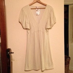 Comfy dress cream with tiny black pika dots .