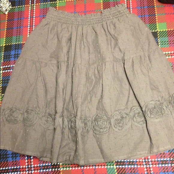 Gray skirt with flower detail on the hem.