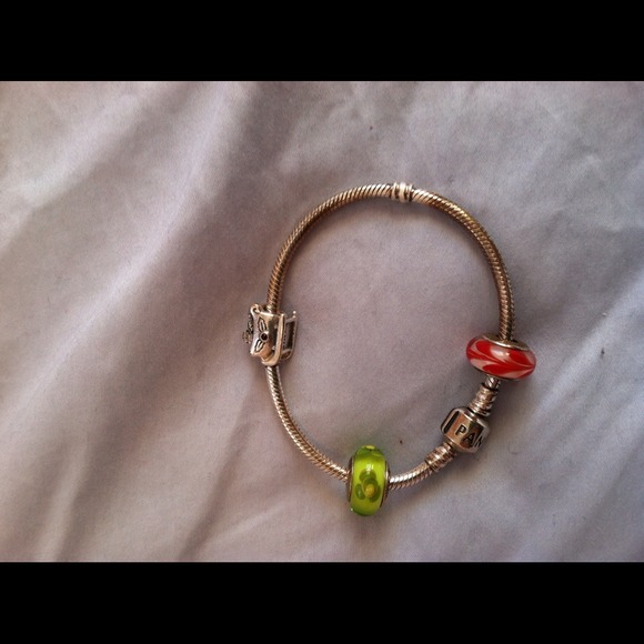Pandora bracelet, never worn, with three charms.