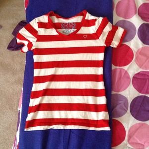 A red striped shirt,has a glittery heart on it.