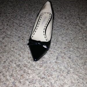 Black patent leather kitten heel.