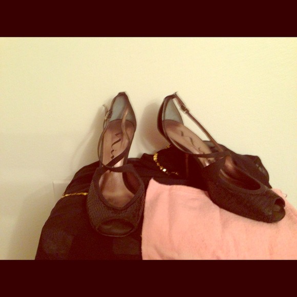 Black sequin shoes with ankle straps.