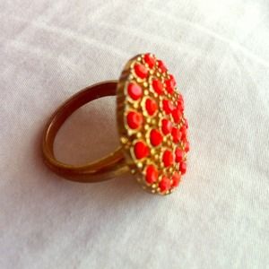 Gold colored cocktail ring with orange details