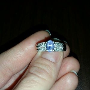 1.5 carrot tanzanite ring surrounded by diamonds