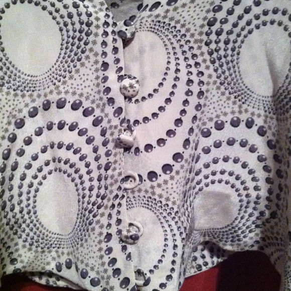 Blouse back is cut out for a sexy peek. Silky - Picture 2 of 3