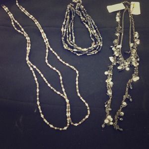 Five necklaces in gray tones