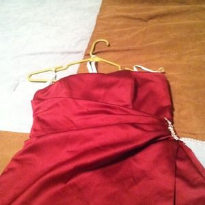 Satin gown with side drape and brooch