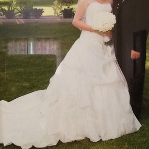 This gown will be available in June. It's ivory.