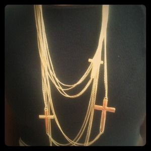 Long gold necklace with 4 crosses.