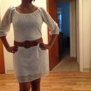 White lace dress with belt.