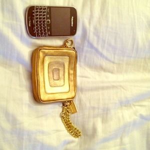 Coach gold wristlet, also has keychain inside.