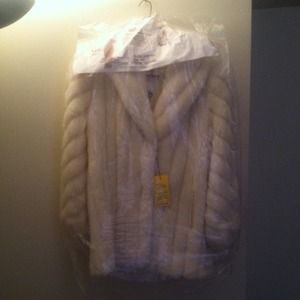 Egg shell colored man-made fur coat.