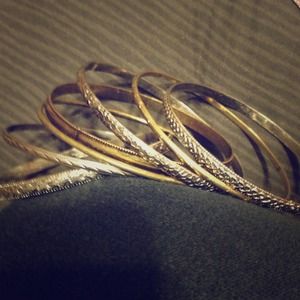 Seven gold, brass, and silver bangles.