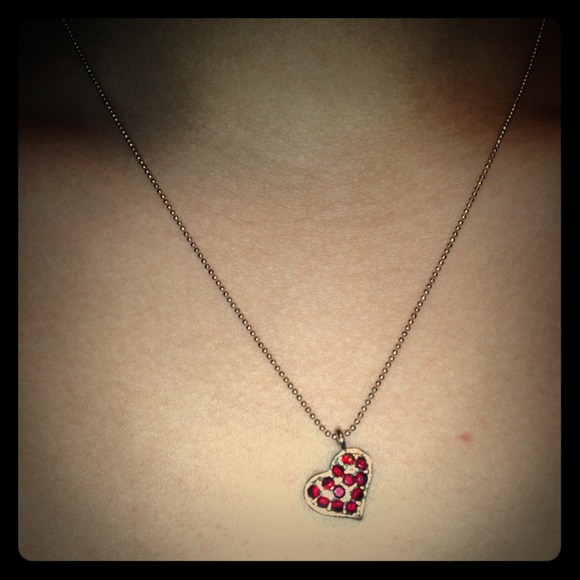 Heart pendant necklace with red stones.