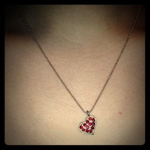 Heart pendant necklace with red stones.