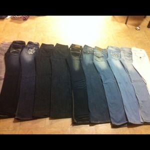 A group of size 0/1 jeans. Various brands