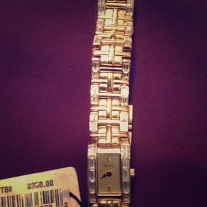 Brand new Bulova gold watch with price tag.