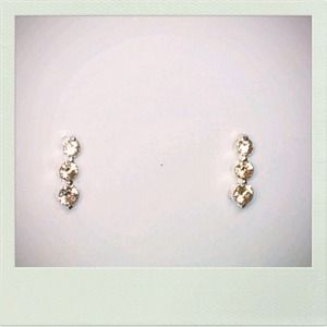 A pale yellow three stone layered earring