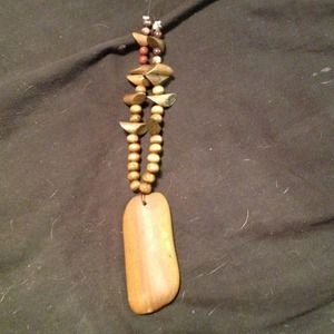 Large stone with wooden beads.