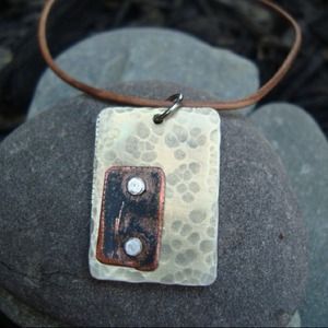 Silver/copper Necklace on brown leather cord.