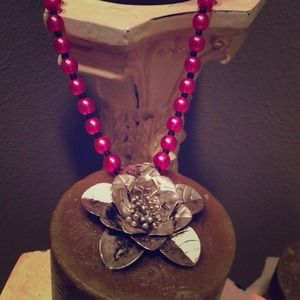 Pink and black flower necklace.