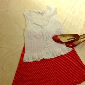 White sleeveless blouse with ruffles.