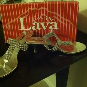 Silver metallic dress shoes with rhinestones.