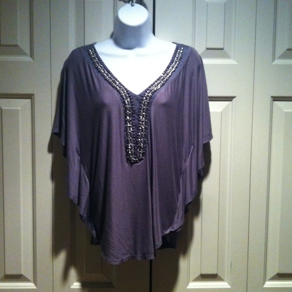 Pretty bat sleeve top with beaded neckline.