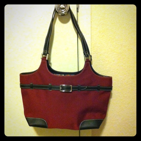 Red purse with black leather like handles and belt