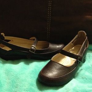 Brown Mary Jane style flats.