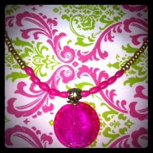 Hot pink glass medallion with gold bead necklace