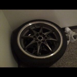 A set of four 17 inch racing rims with tires