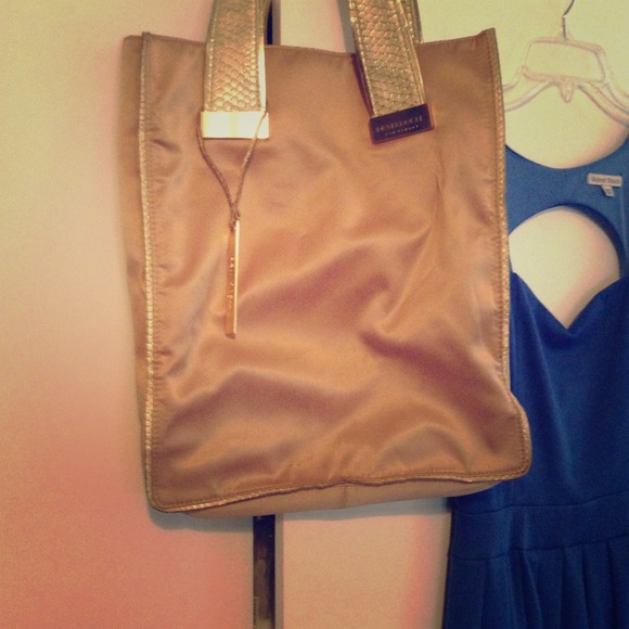 Gold magazine style handbag by Devi Kroell