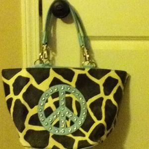 Giraffe design bag with peace sign embellishment