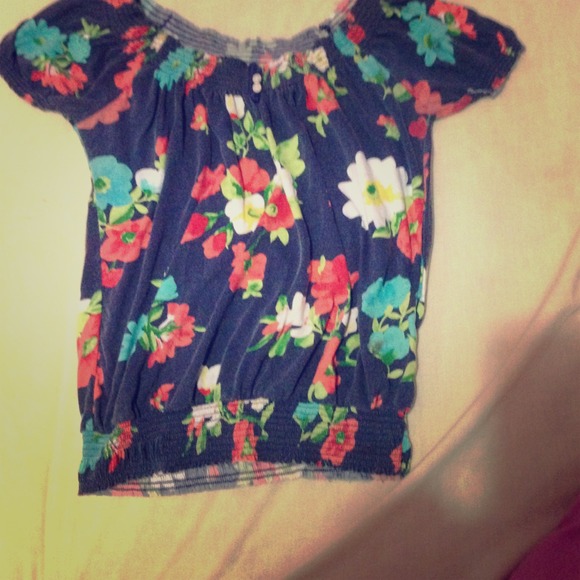 Blue shirt with flowers. Stretchy.