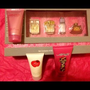 4 miniature perfume, 3 body Lotions, makeup bag