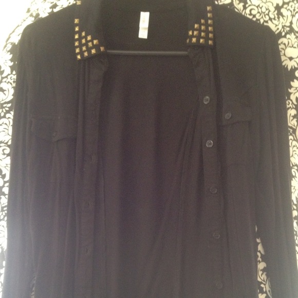 Black long sleeved top with gold studs on shoulder