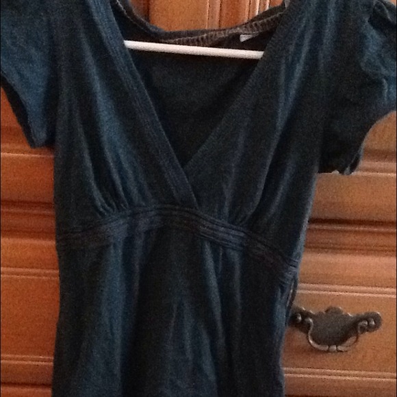 Ties in back. Dark teal color really low v