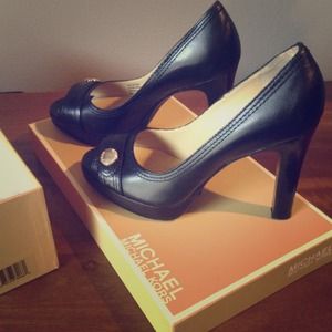 Black leather peep toe Michael Kors platform pumps
