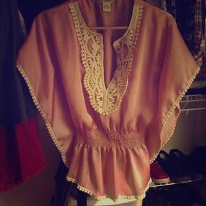 Pink pancho-like top.